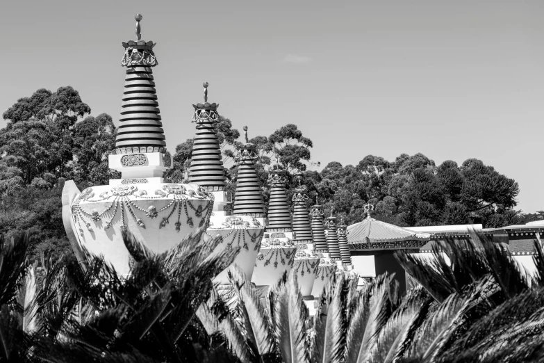 black and white image of a statue in front of trees