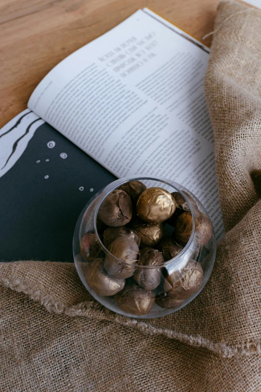 a bowl of nuts and an open book