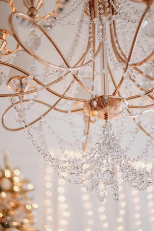 a white chandelier is shining with crystal beads