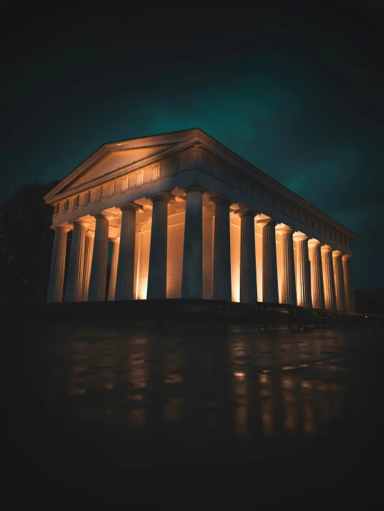 a building with columns and lights inside it