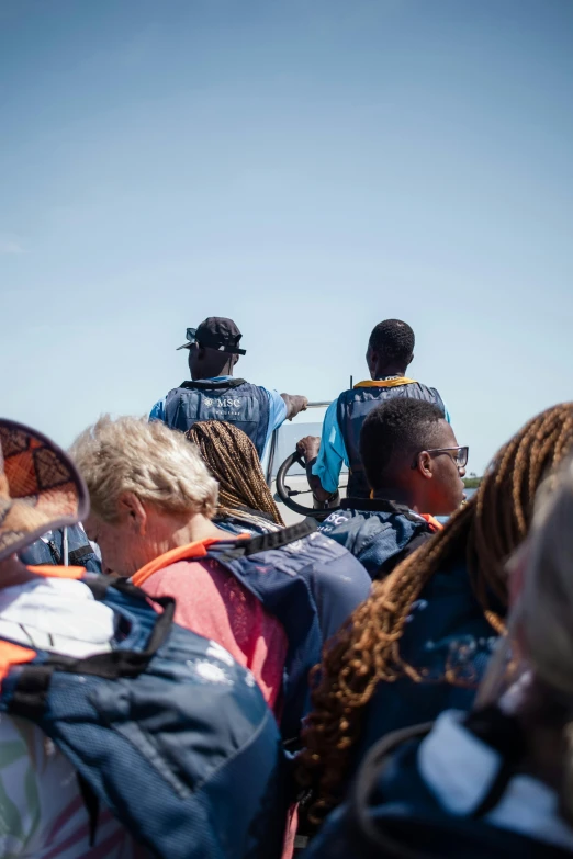 a group of people in a boat looking at the water