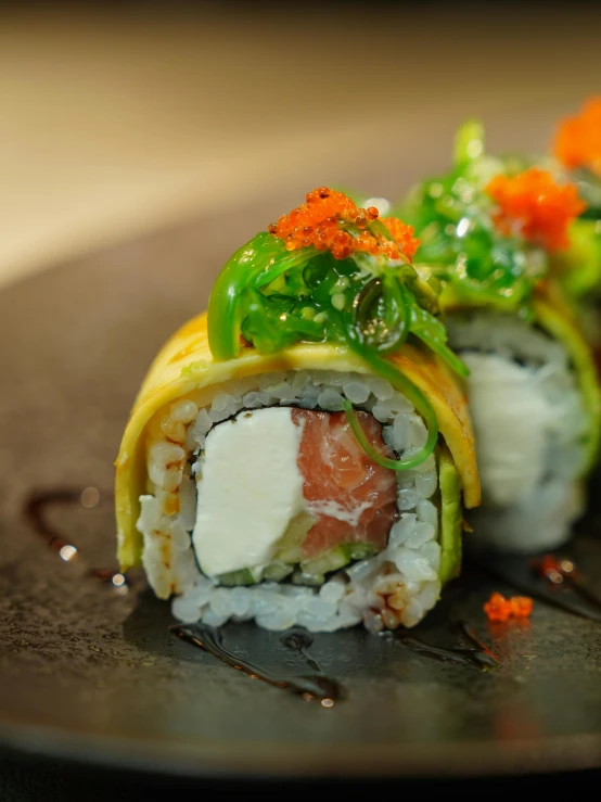 a piece of sushi, with cucumber, carrots and lettuce