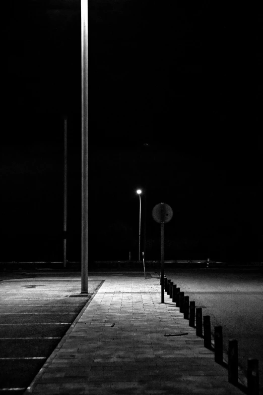 some poles are in the dark by a street light