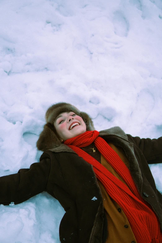 a man that is laying in the snow