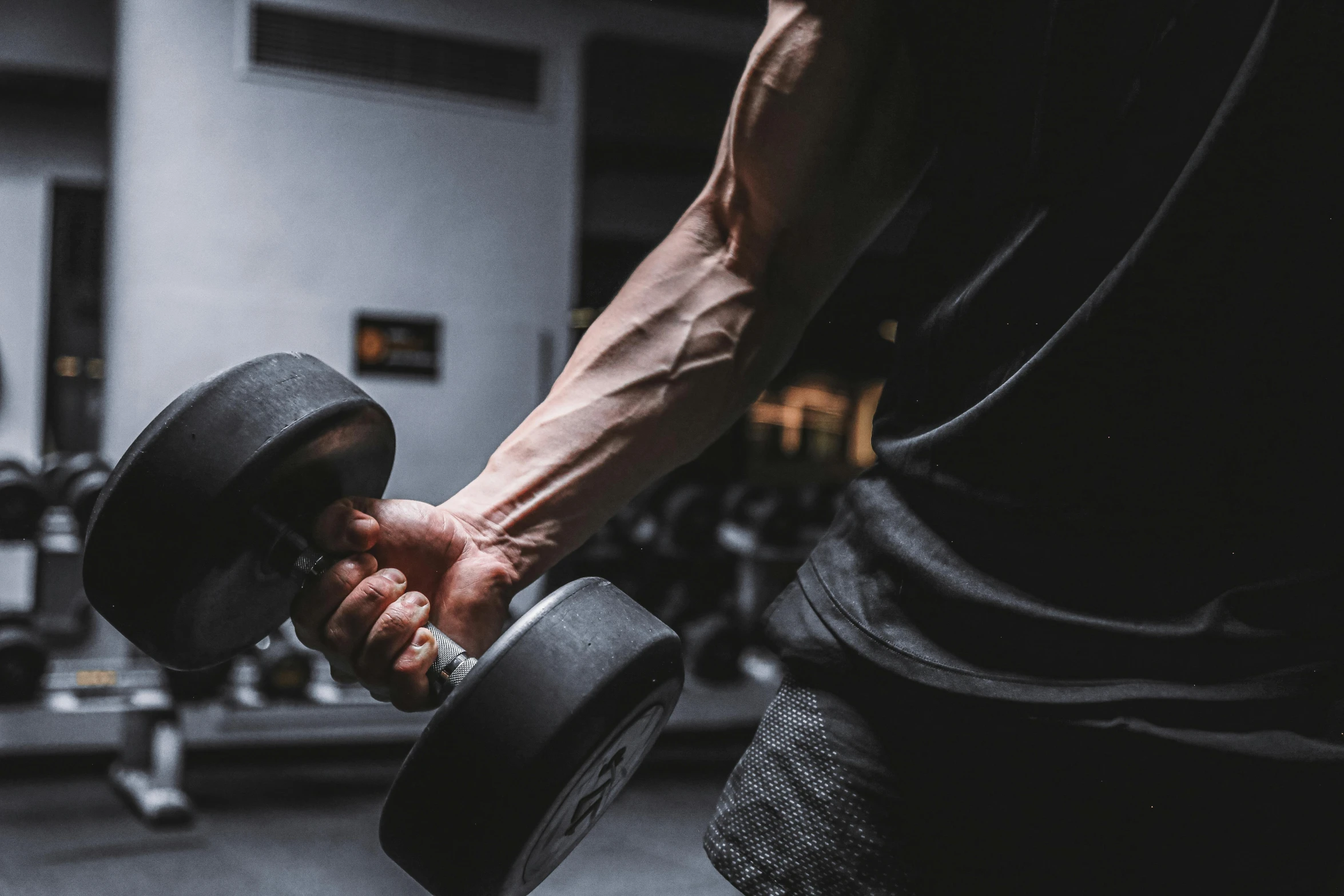 a person holding a dumbble dumbbell in a gym