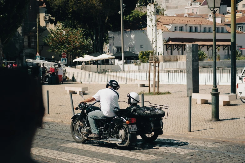 a man on a motorcycle riding in the street