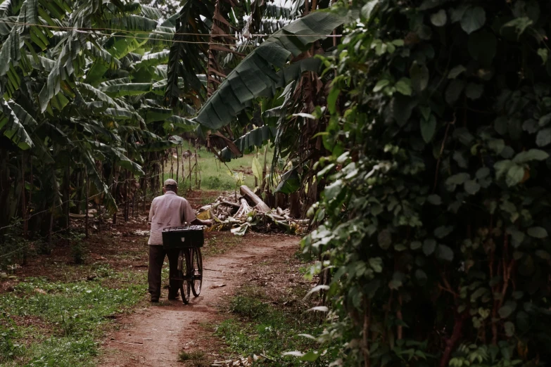 a man riding a bike down a dirt road