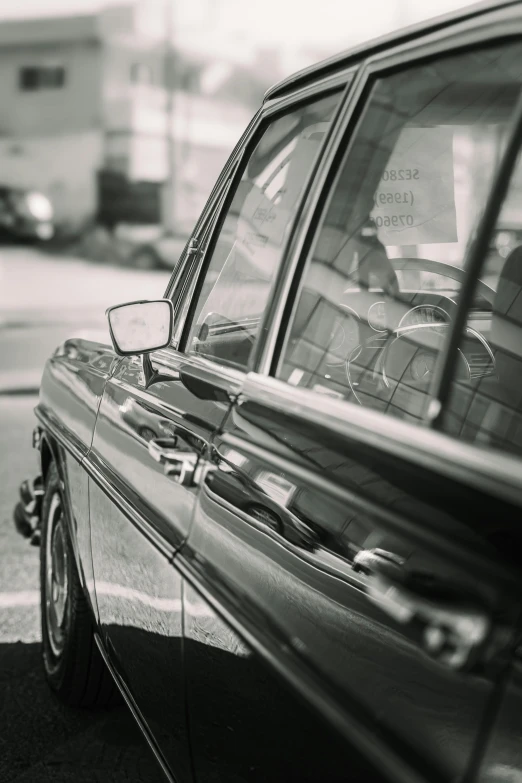 an old car that is sitting on the side of a road