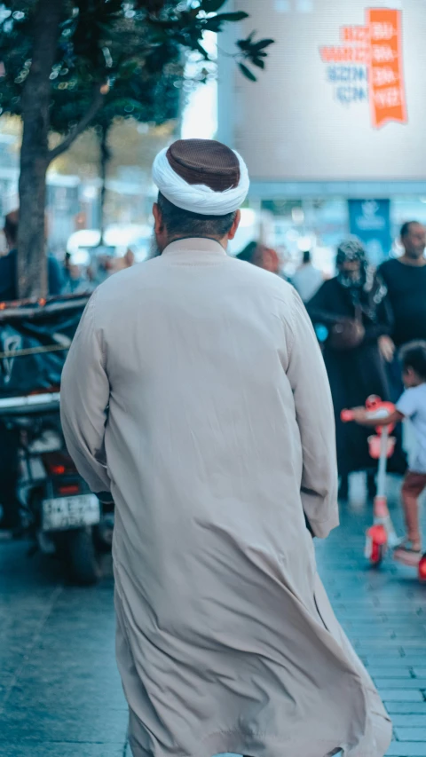 a man walking on the sidewalk in the middle of the street