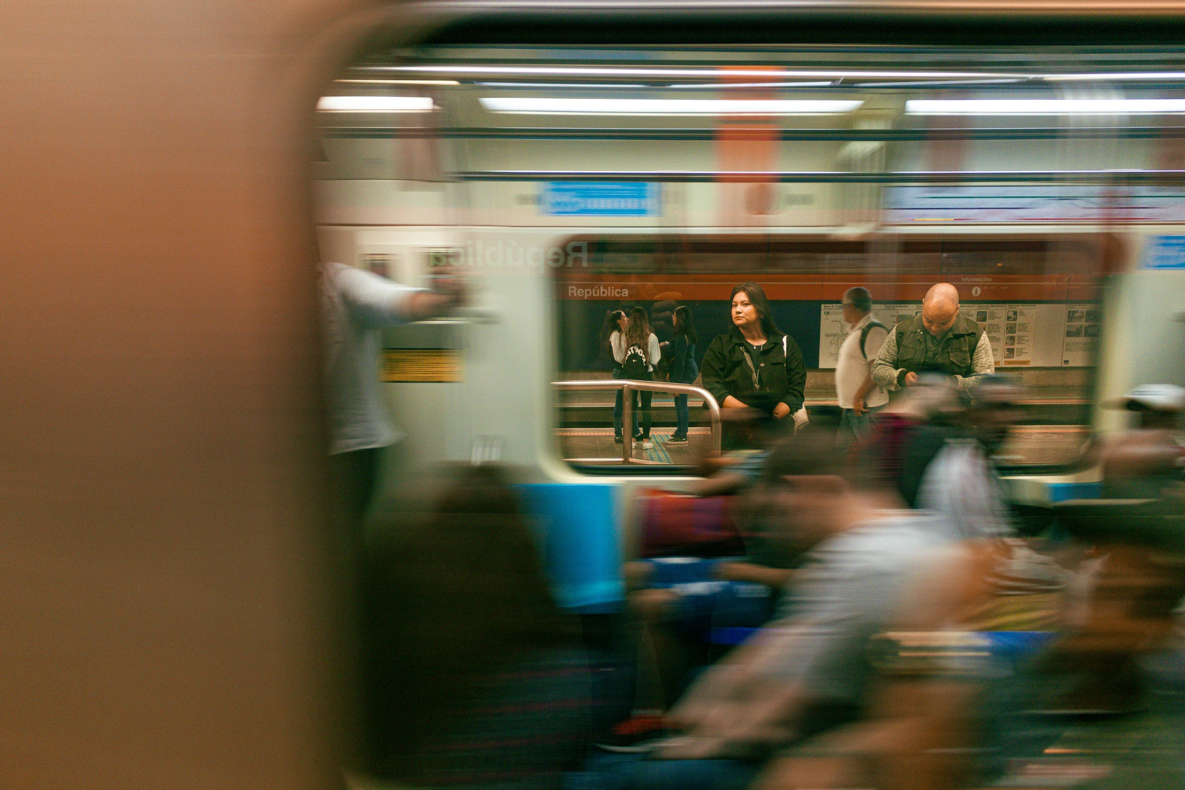 a blurry po shows people waiting for the subway