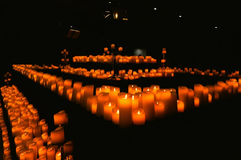 a po of many candles inside a large room