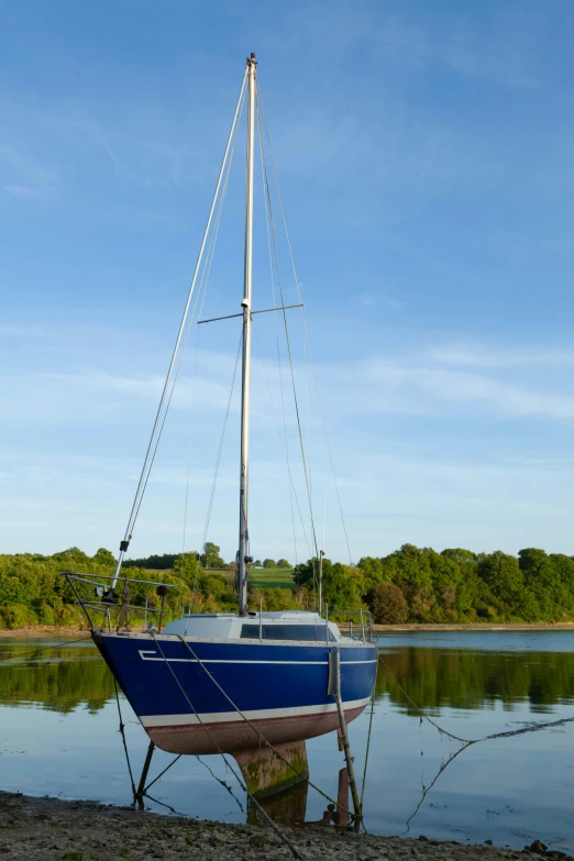 a sailboat is tied up at the dock in the water