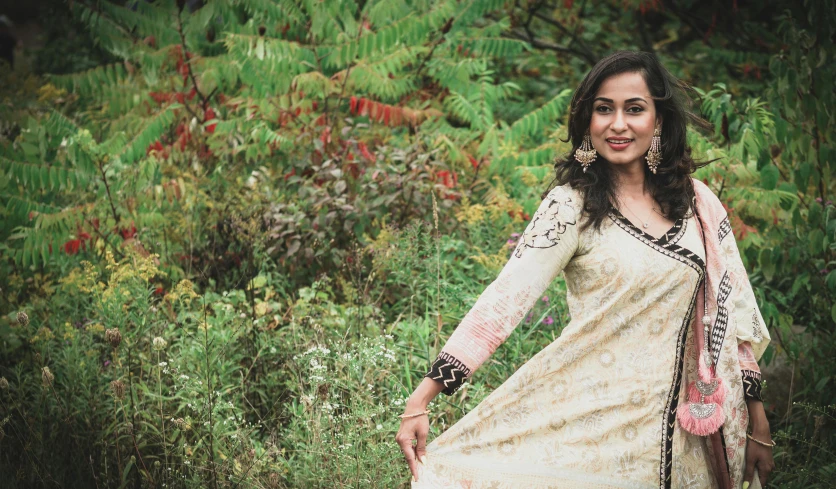 a beautiful woman in white dress standing on grass