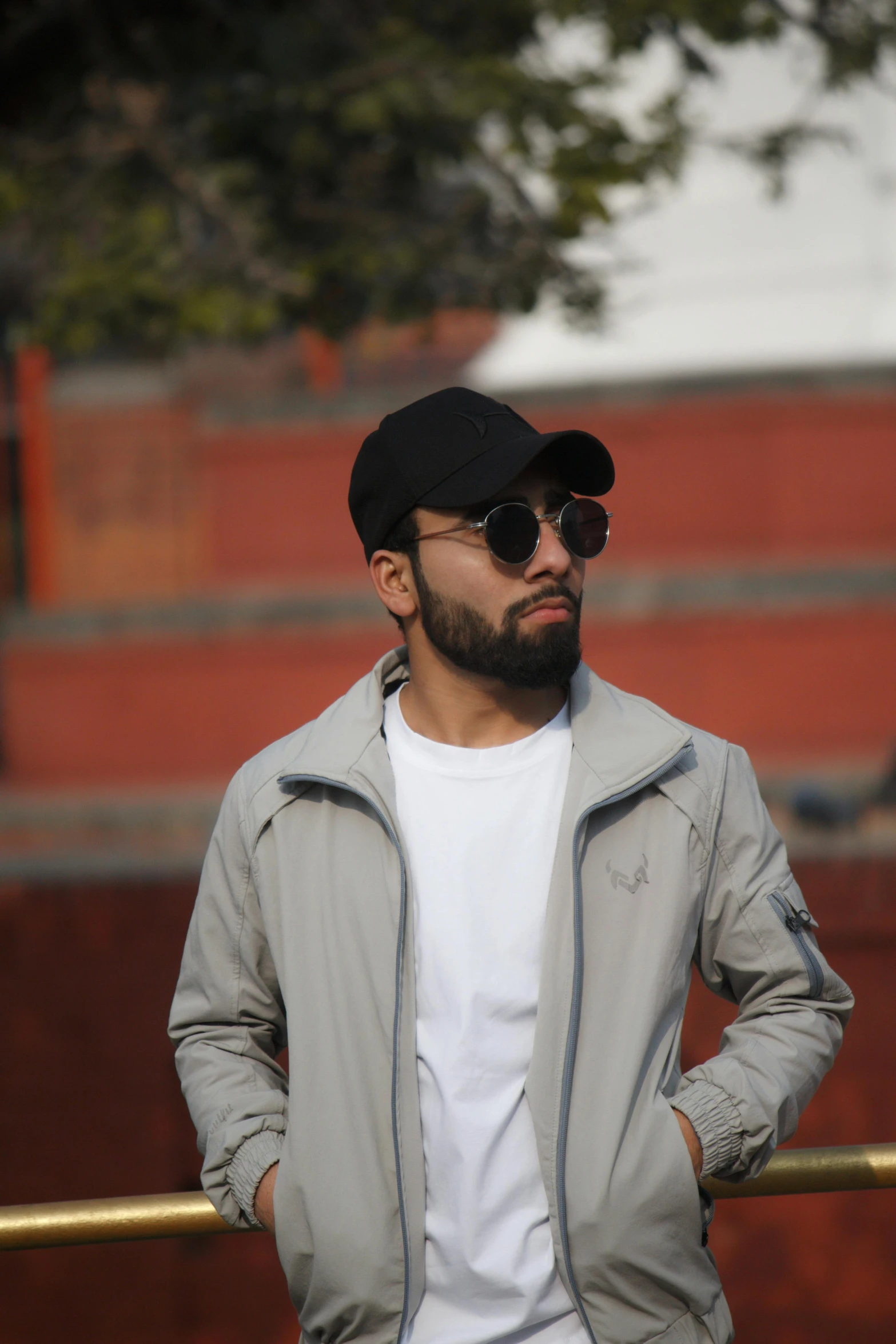 a man in a black hat and sunglasses looking to his left