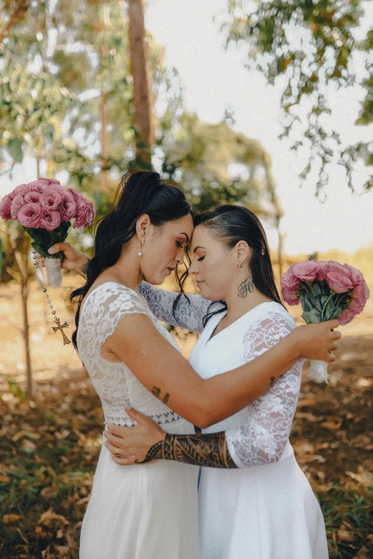 two women hug each other in the woods