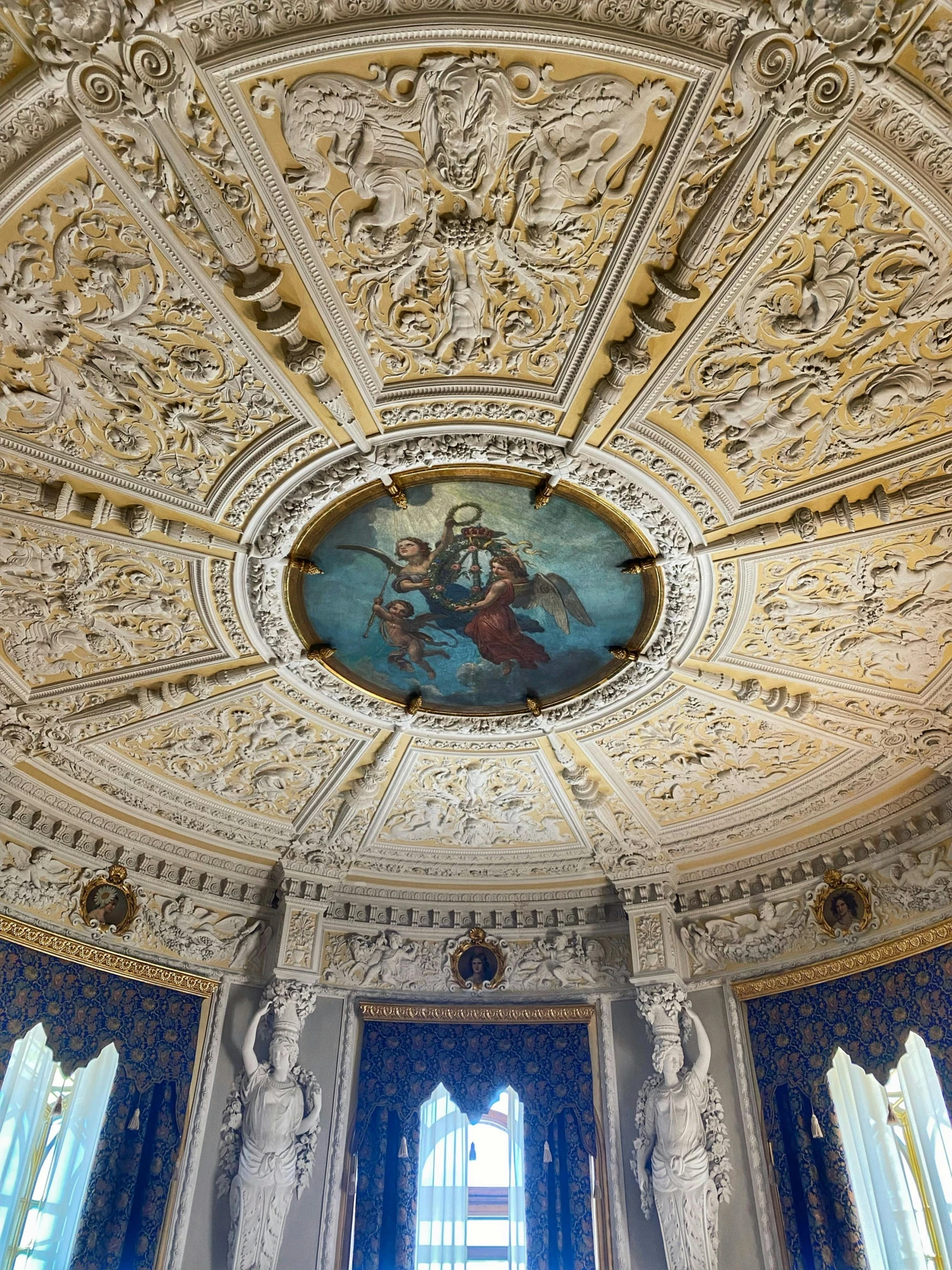 large white ceiling with stained glass and elaborate design