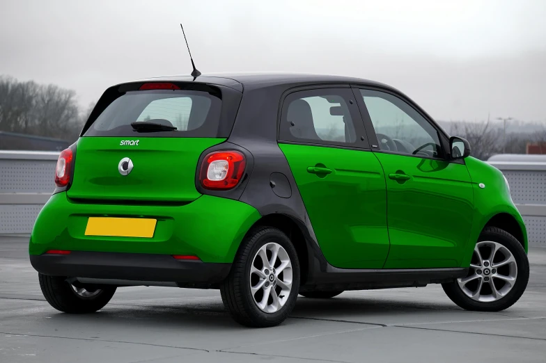 green smart car is parked on the concrete