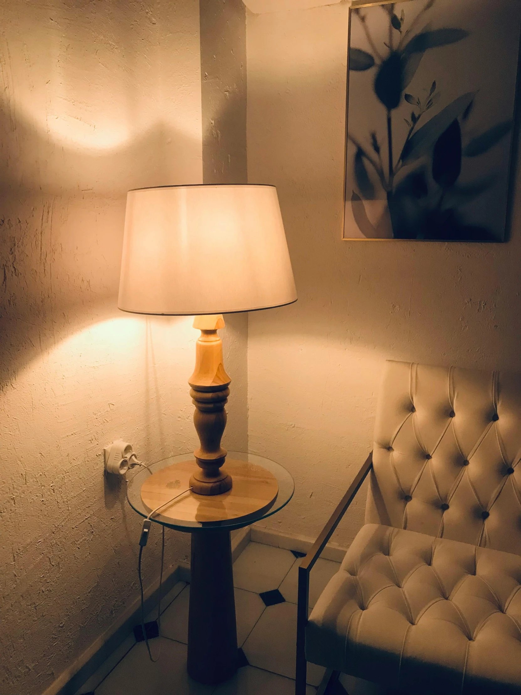 the table lamp has been placed next to the chair