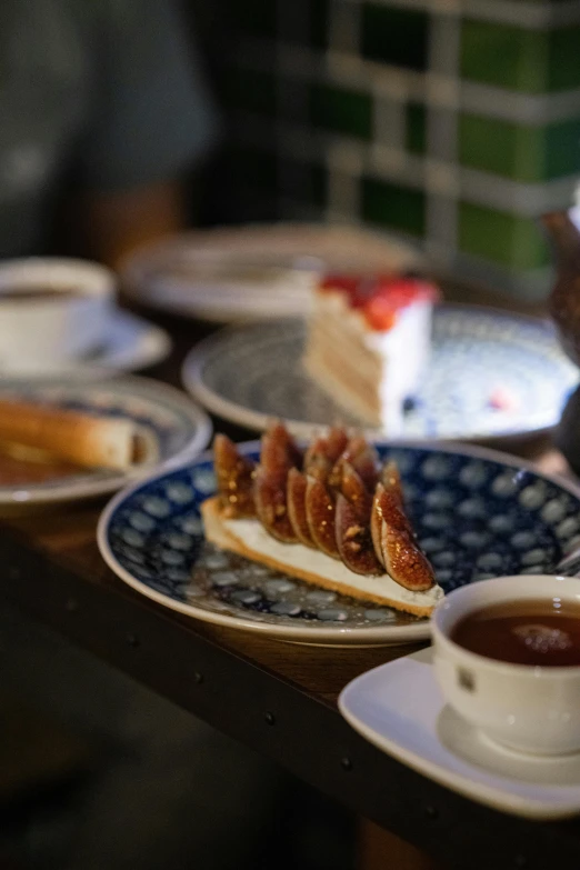 several plates are displayed with sandwiches and sauce