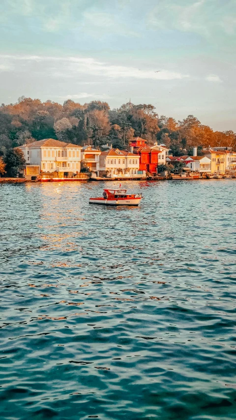 two boats on the water near some buildings