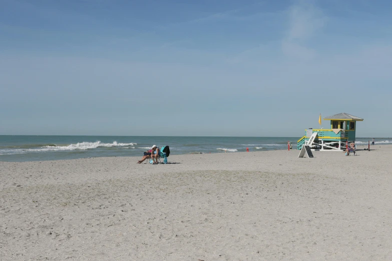 a small beach has a life guard hut near the water