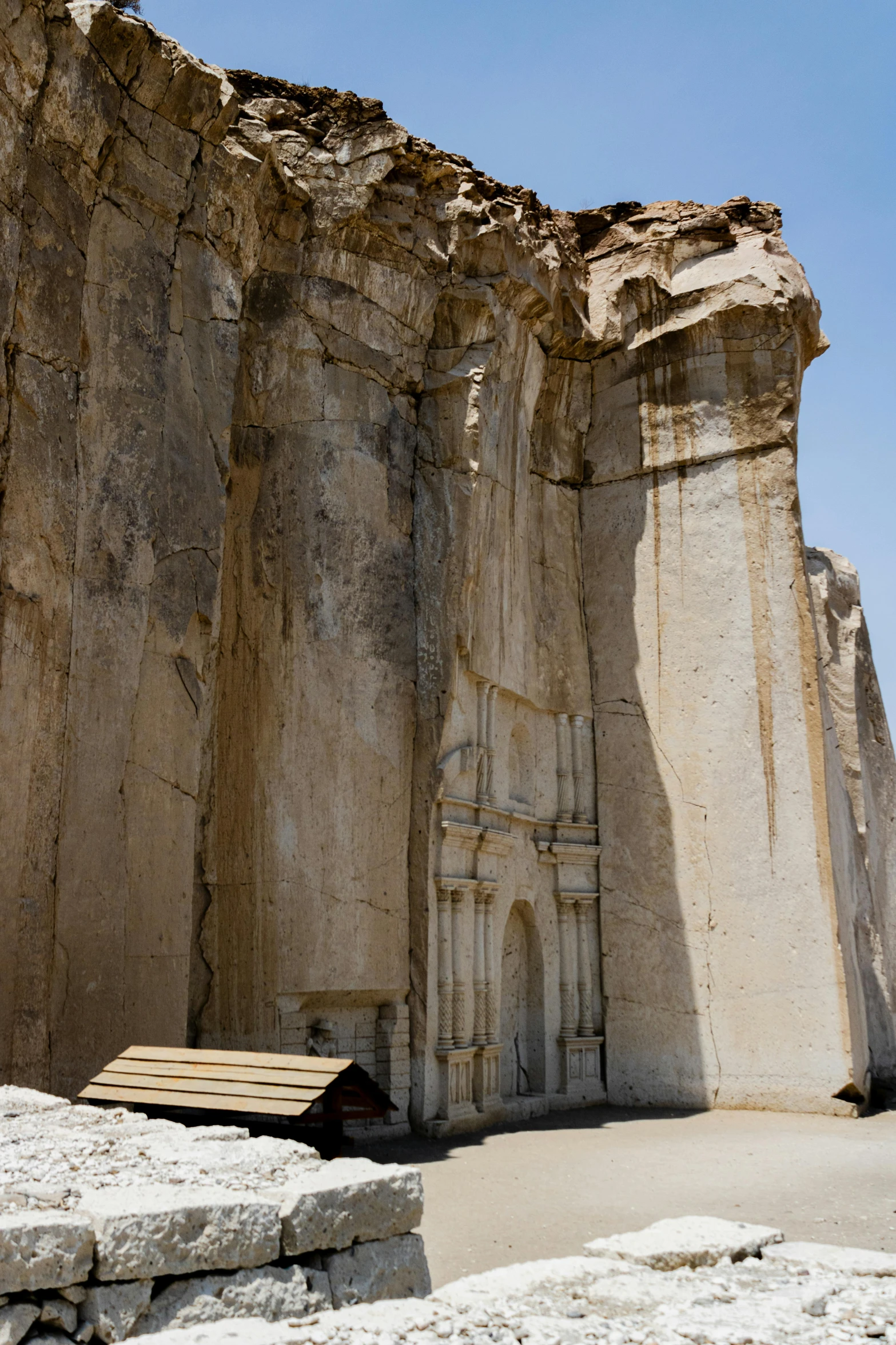 stone structures, with large pillars and a small hut below