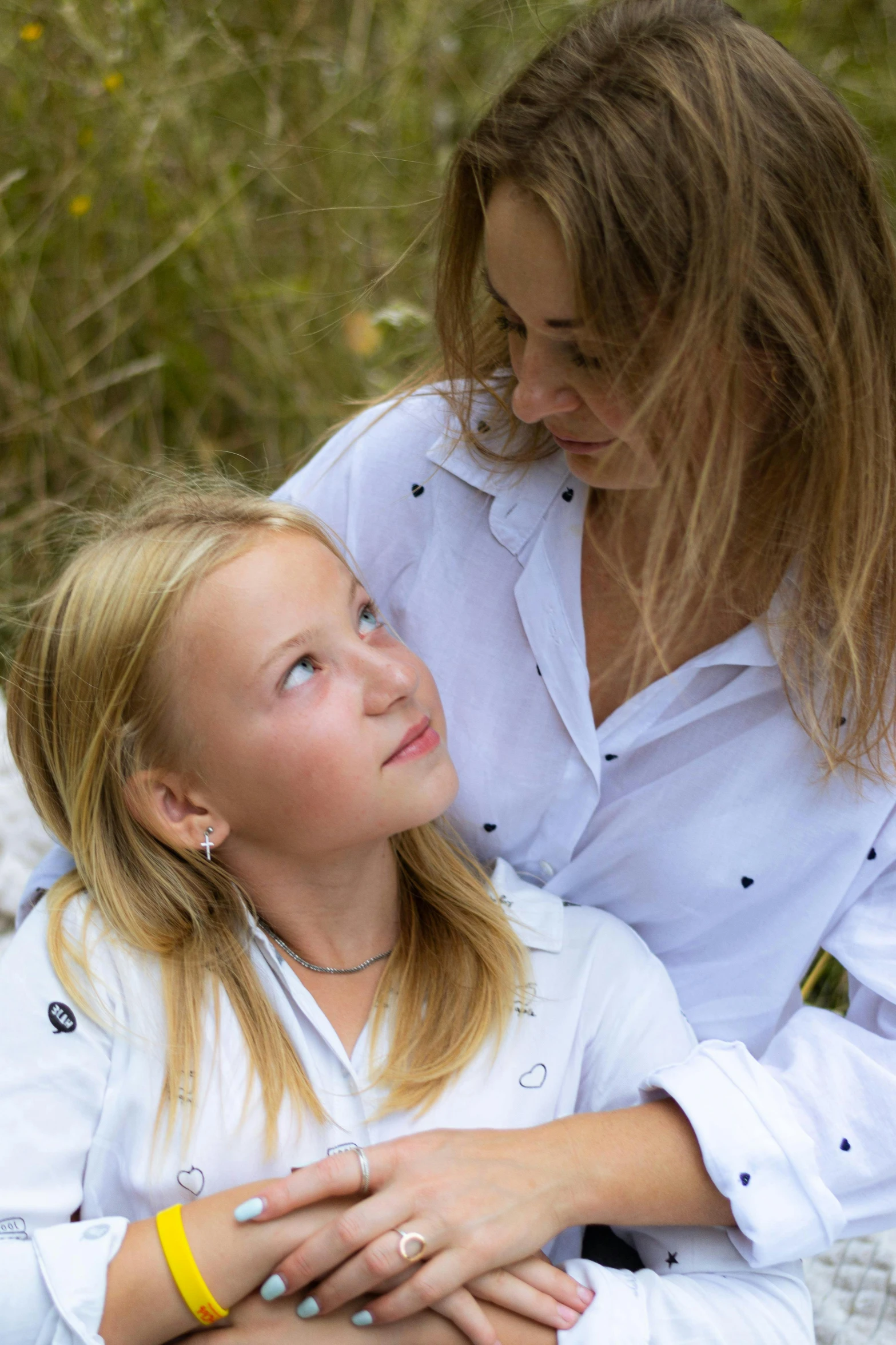 a girl with her arm around her parent