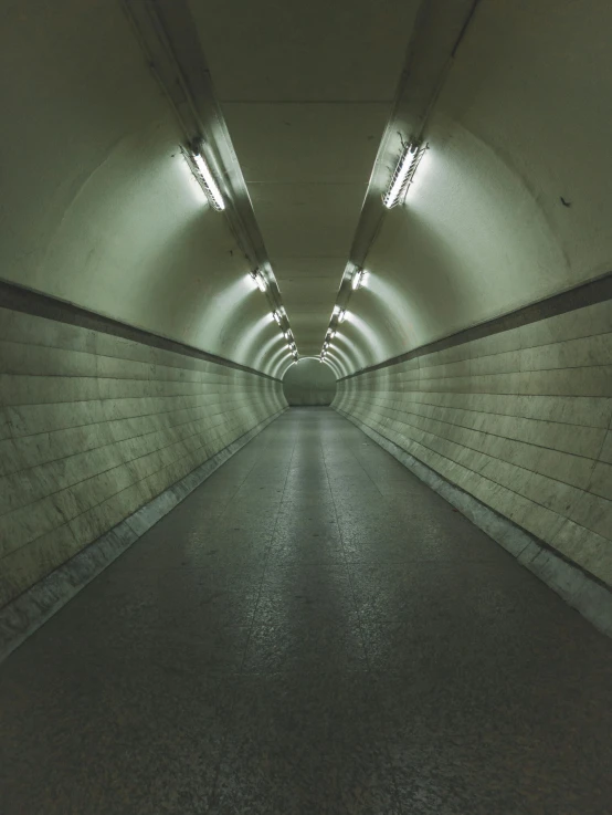 a tunnel is shown with light from several lights