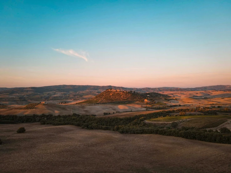 a large mountain and desert area during the sunset