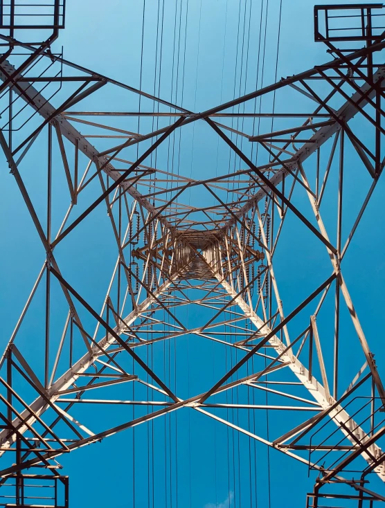 a very tall metal tower that has power lines