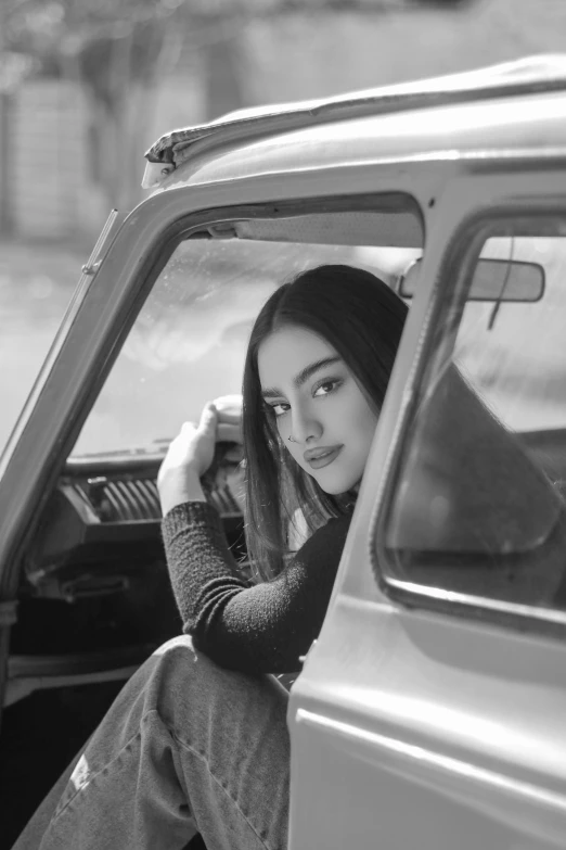 woman in car with long hair sitting next to car window