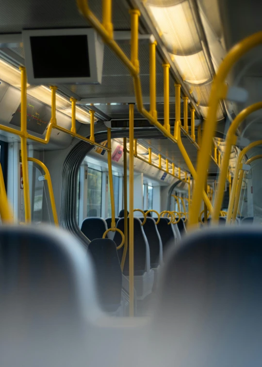 inside view of a modern bus with yellow painted trim