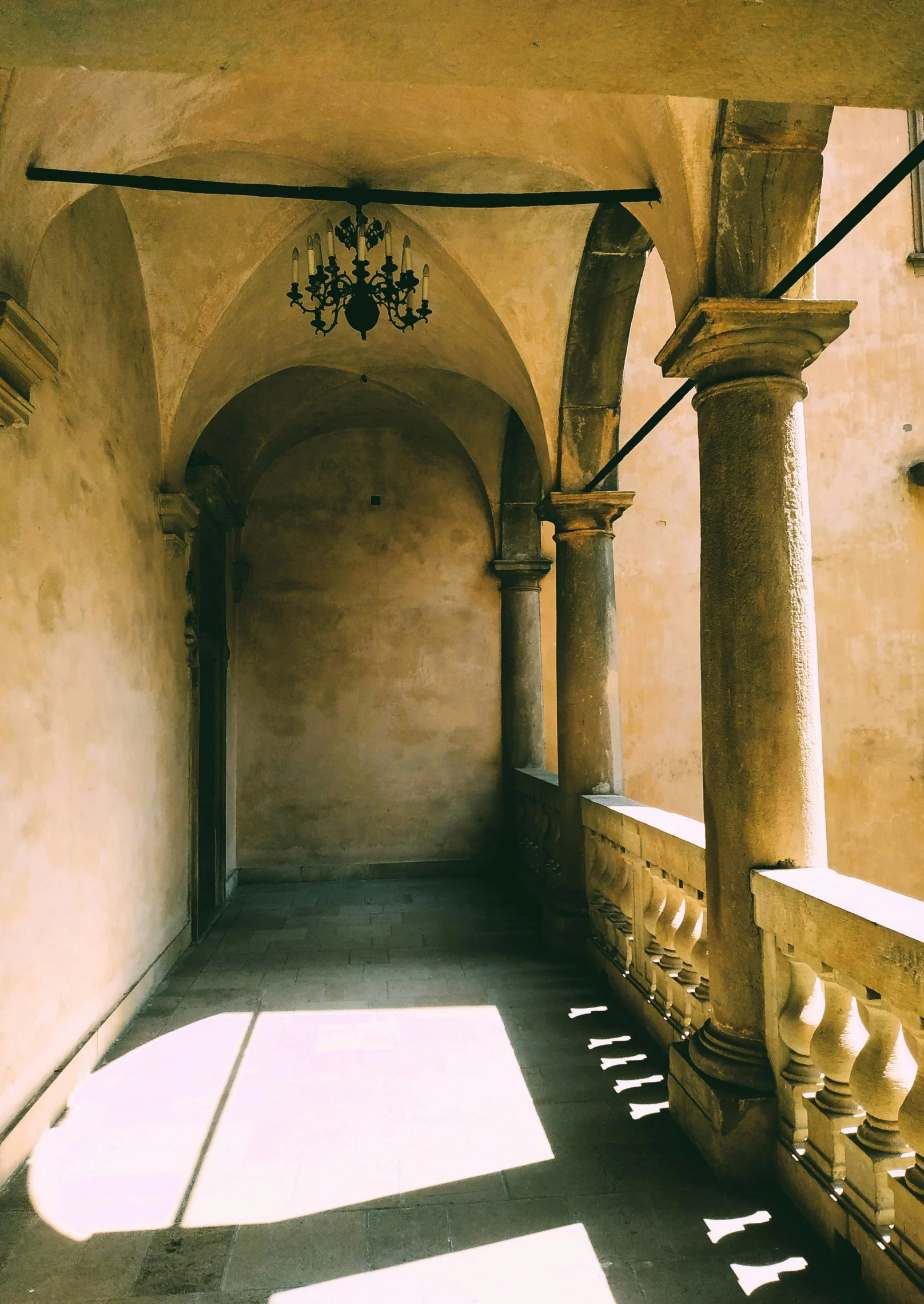 an arched hallway has been sunlit by a window