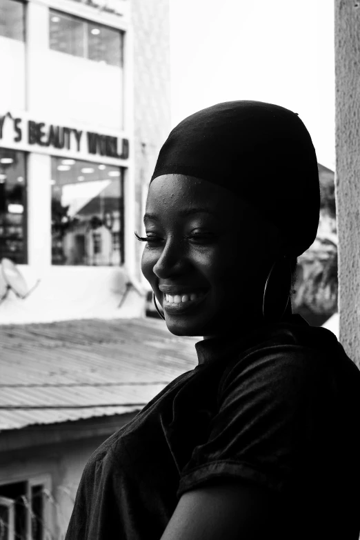 black and white portrait of smiling woman with headband