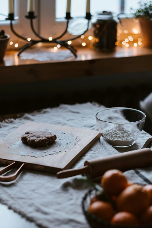 some food on a table next to some candles