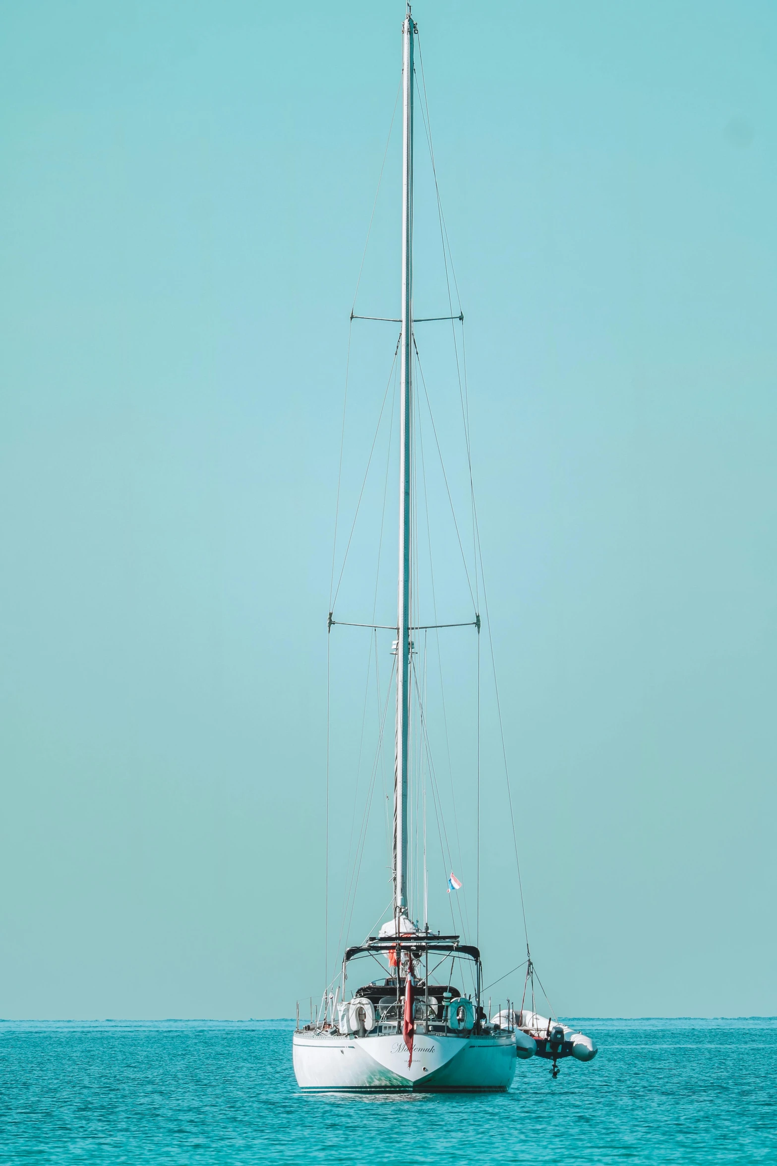 a large boat sailing across a wide blue sea