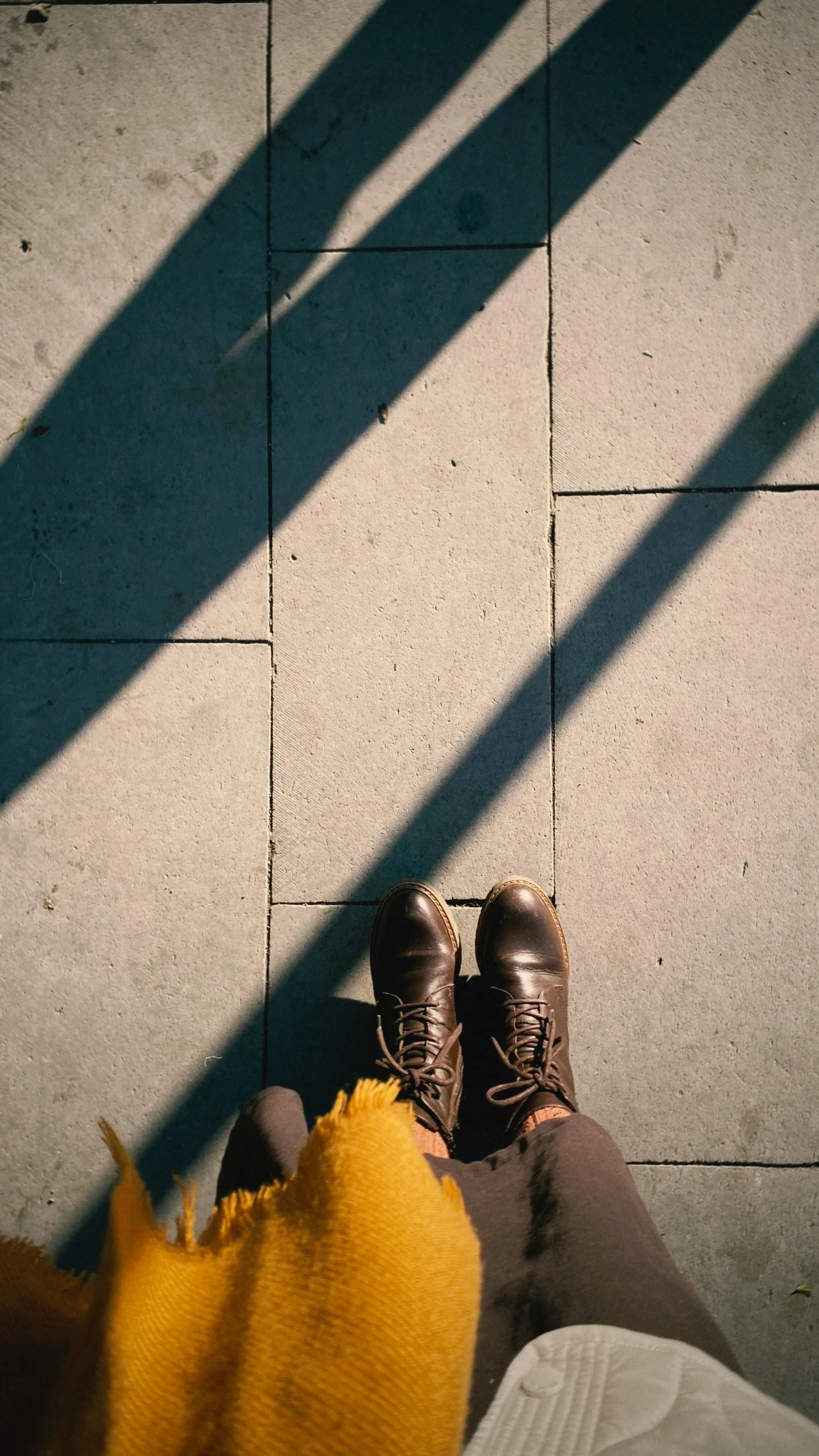 legs with shoes in between them on the ground