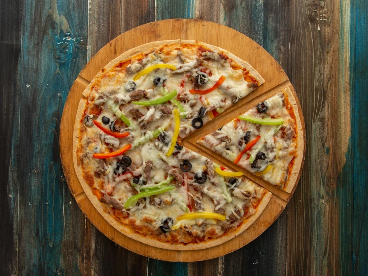 a pizza sitting on top of a wooden pan