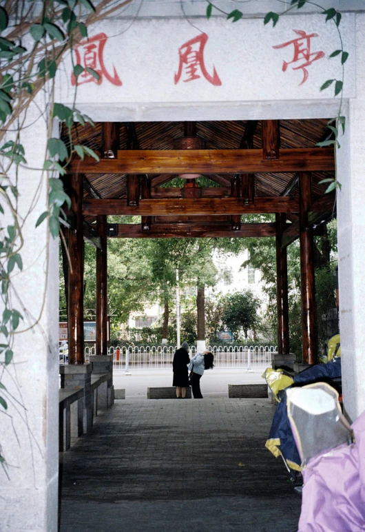 a couple of people walking up to a very large entrance