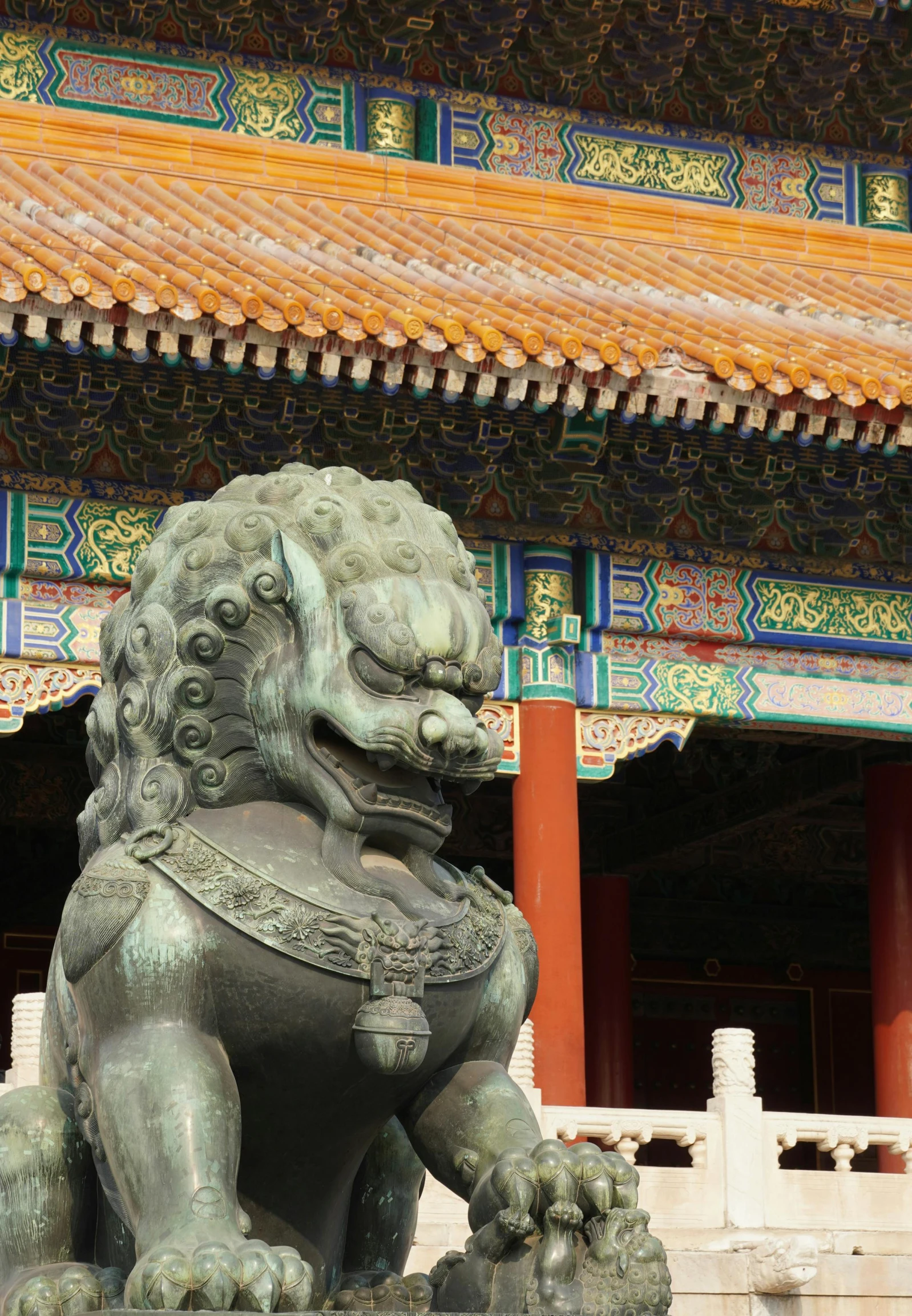 a stone lion sculpture stands in front of an asian building