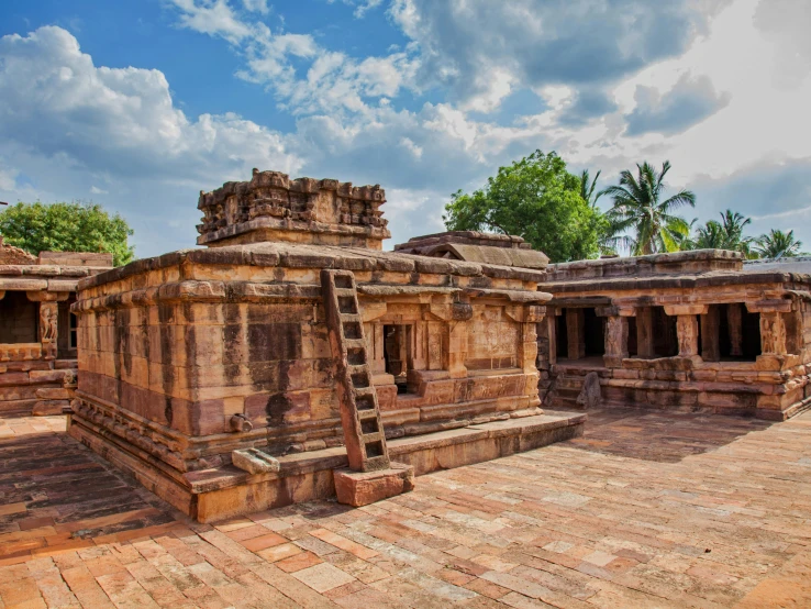 stone architecture at the base of a building with trees in background