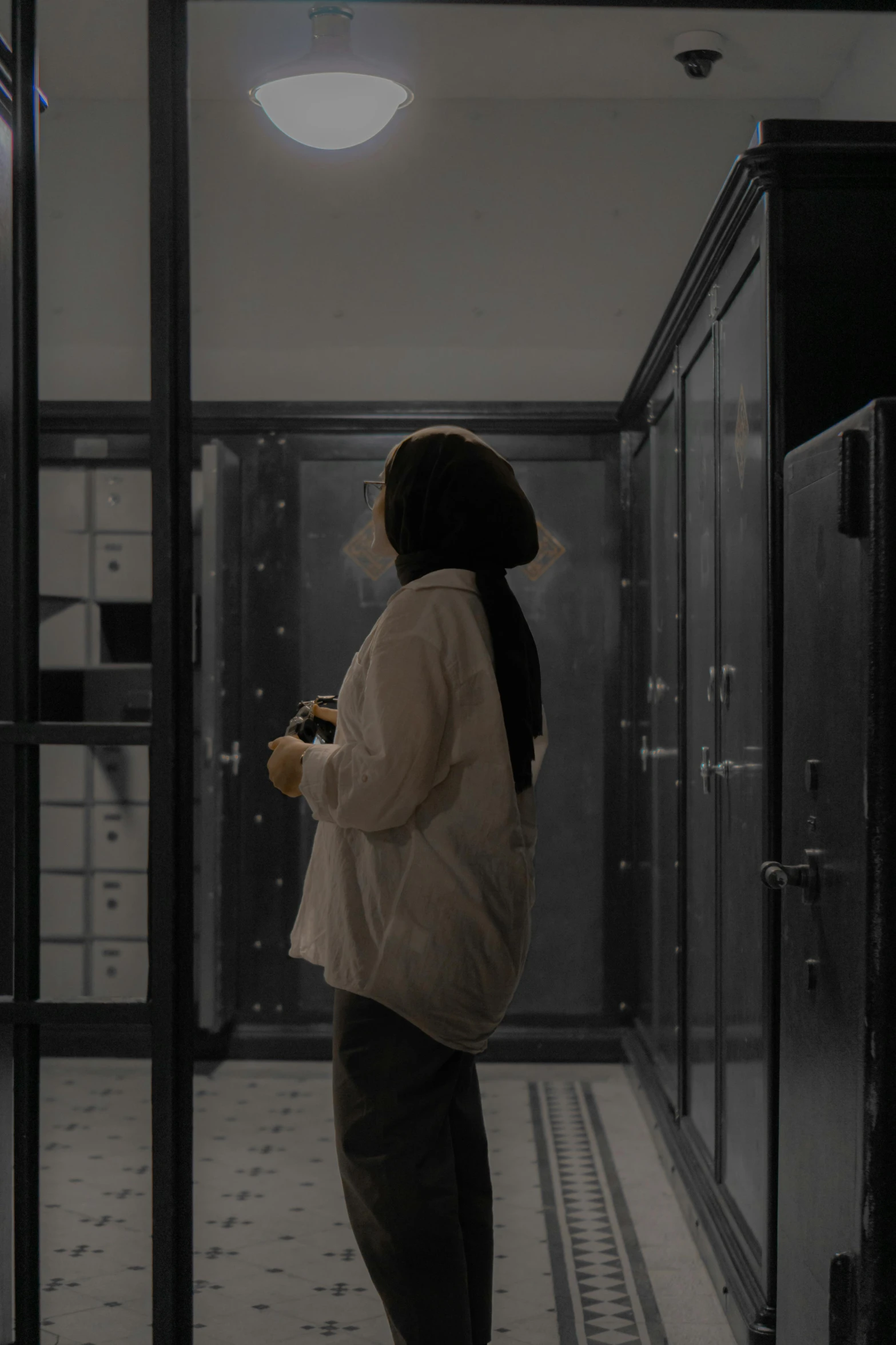 a woman standing in front of some glass elevators