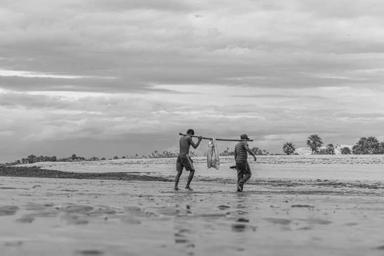 two men on a beach preparing to fish