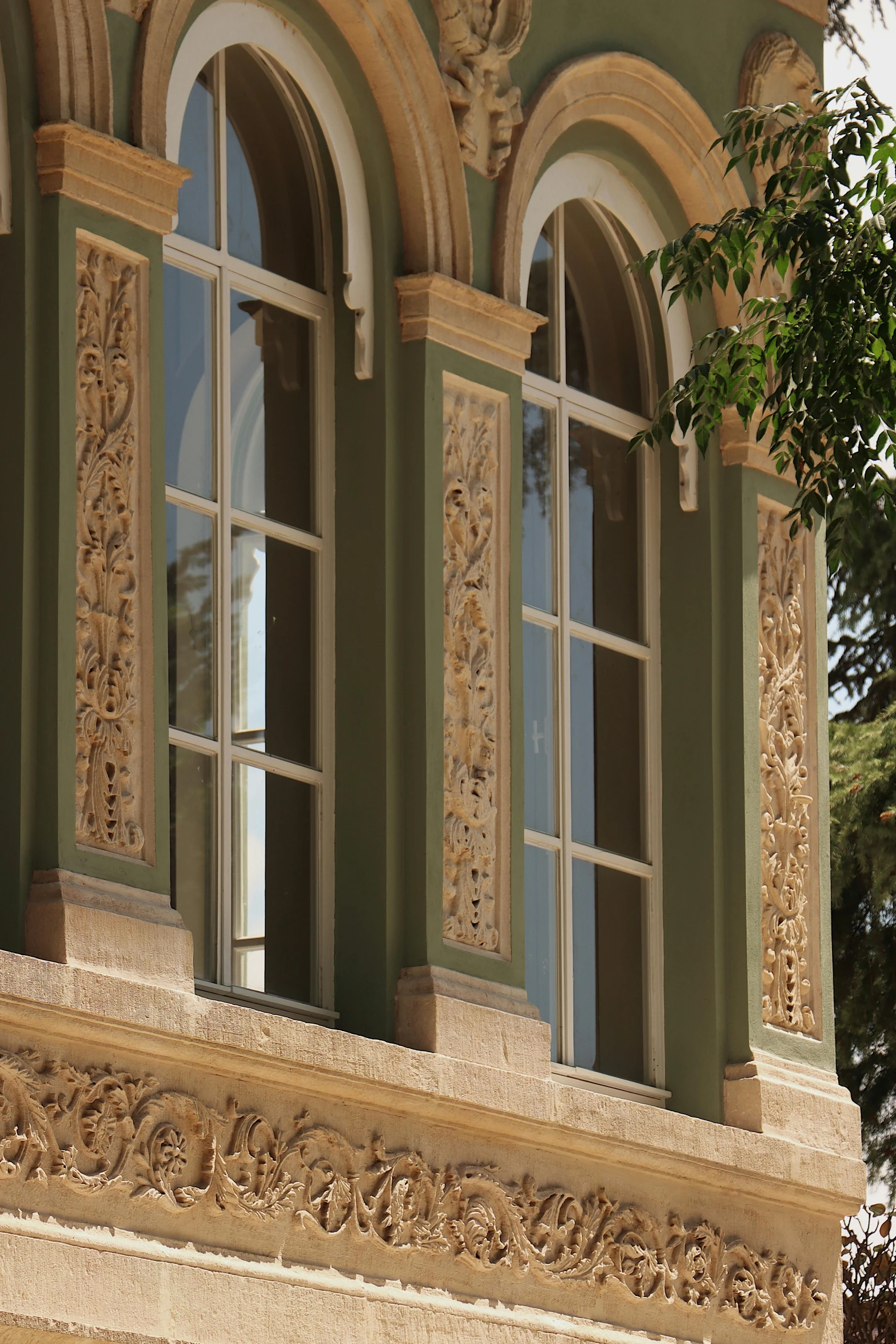 an ornate building with arched windows on the top