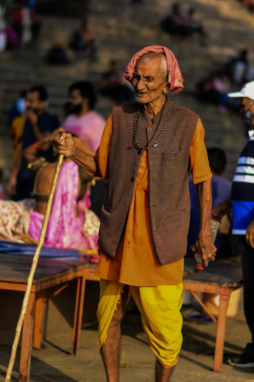 an old man with a stick is walking outside