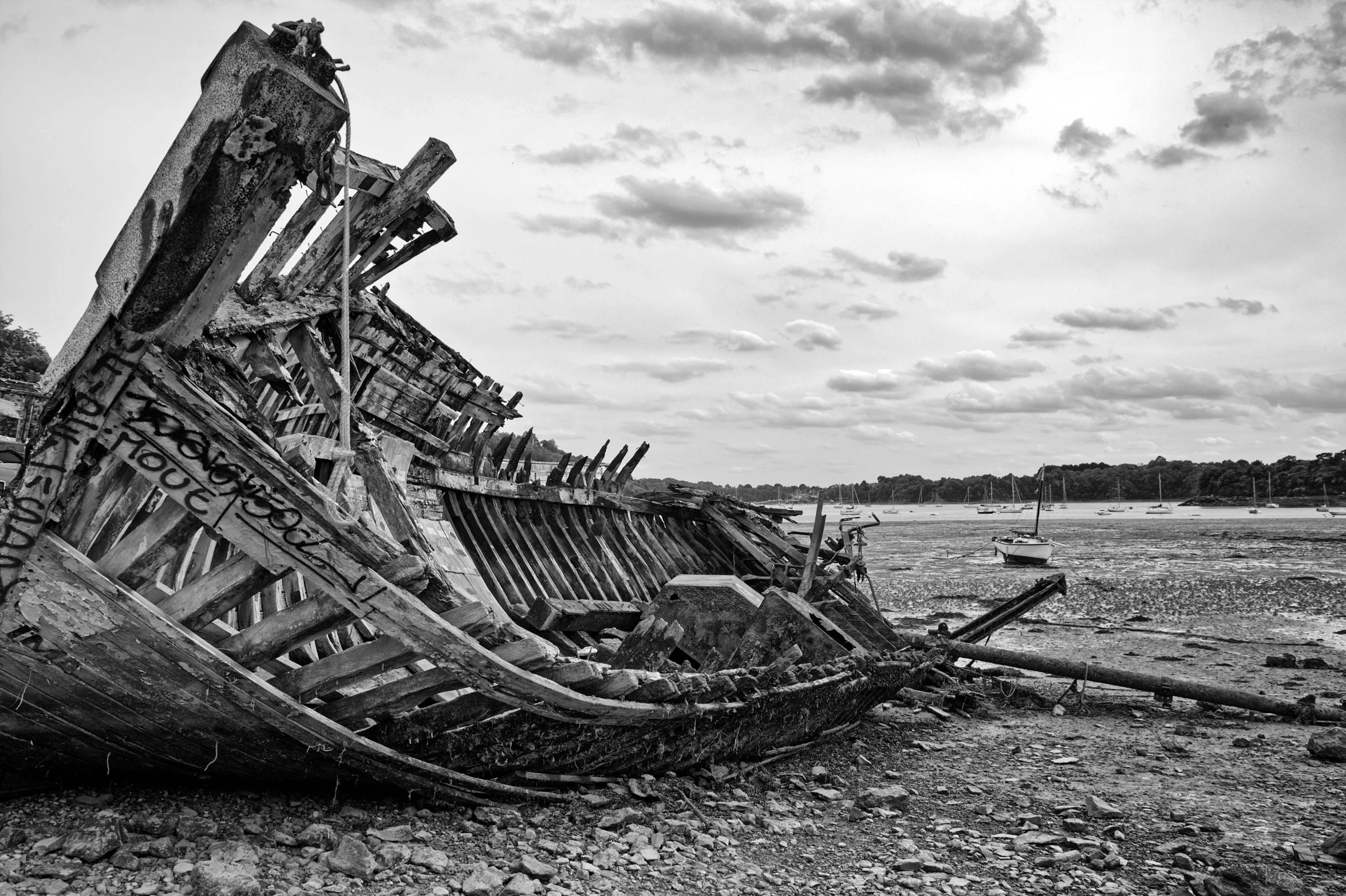 a ship that is sitting on the shore in the mud