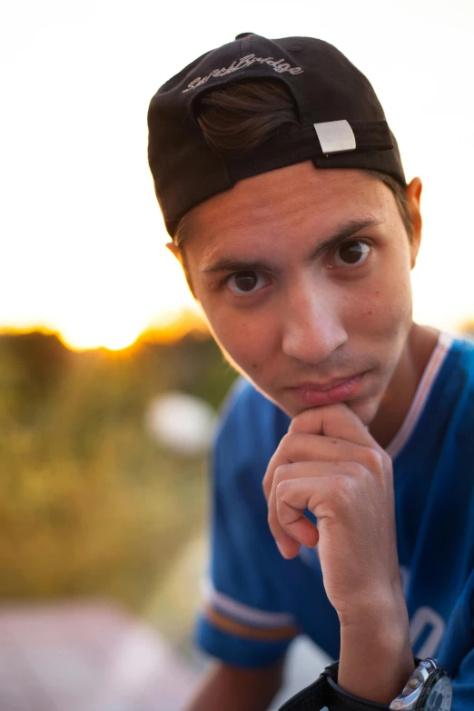 a young man with an id tag wearing a hat