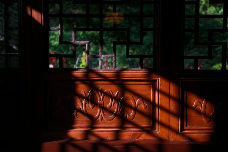 the shadow of a wooden door and iron grill