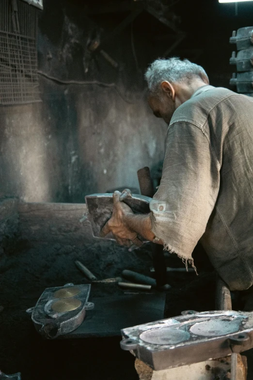 an old man cooking soing on a large stove