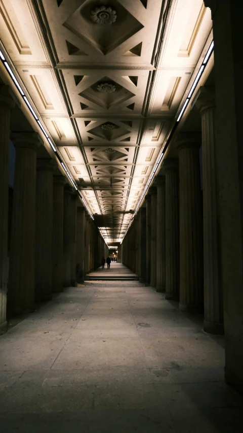 an indoor walkway lit up by many lights